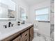Stylish bathroom featuring a double vanity with farmhouse-style cabinets and modern fixtures at 1100 Webb Dr, Clearwater, FL 33755