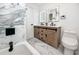 Modern bathroom featuring marble tile, double vanity, and sleek fixtures at 1100 Webb Dr, Clearwater, FL 33755