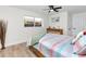 Inviting bedroom with wood-look floors, natural light, and a colorful quilt at 1100 Webb Dr, Clearwater, FL 33755