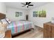 Bedroom featuring wood-look floors, a large window, and modern furnishings at 1100 Webb Dr, Clearwater, FL 33755