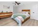 Bright bedroom with wood-look floors, dresser, and a charming accent pillow at 1100 Webb Dr, Clearwater, FL 33755