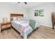 Cozy bedroom with wood-look floors, a large window, and modern furnishings at 1100 Webb Dr, Clearwater, FL 33755