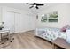 Bright bedroom features new floors, a ceiling fan, and double closets for ample storage at 1100 Webb Dr, Clearwater, FL 33755