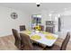 Bright dining room features new flooring, a modern light fixture, and a view of the pool at 1100 Webb Dr, Clearwater, FL 33755