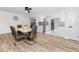 The dining room features new vinyl flooring and white cabinets with modern stainless steel appliances at 1100 Webb Dr, Clearwater, FL 33755