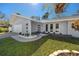 Modern home exterior featuring a well-manicured lawn, walkway, and stylish architectural details including statement windows at 1100 Webb Dr, Clearwater, FL 33755