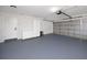 Clean and organized garage space with built-in storage and painted floor at 1100 Webb Dr, Clearwater, FL 33755