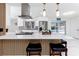 Gourmet kitchen boasts island seating, stainless steel appliances, and bright white countertops at 1100 Webb Dr, Clearwater, FL 33755