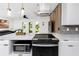 Well-lit kitchen showcases white cabinetry, a modern oven, and an island with marble countertops at 1100 Webb Dr, Clearwater, FL 33755