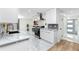 Modern kitchen with sleek countertops, stainless steel appliances, and marble floors at 1100 Webb Dr, Clearwater, FL 33755