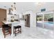 Modern kitchen with island barstool seating and stainless steel appliances offering backyard view at 1100 Webb Dr, Clearwater, FL 33755