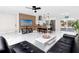Bright living area with open floorplan, a stylish TV display and island seating adjacent to the kitchen at 1100 Webb Dr, Clearwater, FL 33755