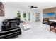 Bright living area with marble floors, adjacent to island, and kitchen with barstool seating at 1100 Webb Dr, Clearwater, FL 33755