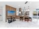 Bright living area with open floorplan, a stylish TV display and island seating adjacent to the kitchen at 1100 Webb Dr, Clearwater, FL 33755