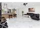 Bright, open living area features an island with barstool seating and access to kitchen and backyard at 1100 Webb Dr, Clearwater, FL 33755