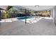 A beautiful screened pool featuring stone-like tile and mature landscaping, perfect for relaxing and enjoying the outdoors at 1100 Webb Dr, Clearwater, FL 33755