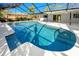 A sparkling in-ground screened pool with a refreshing blue hue, surrounded by a spacious deck at 1100 Webb Dr, Clearwater, FL 33755