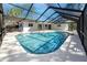 A refreshing screened-in pool features a spacious deck and clear blue water, perfect for outdoor relaxation at 1100 Webb Dr, Clearwater, FL 33755