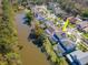 Overhead view of homes with screened pools bordering brown pond showcasing community's waterfront appeal at 11121 Clayridge Dr, Tampa, FL 33635