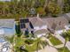 Aerial view of home with solar panels, complemented by lush greenery and nearby water at 11121 Clayridge Dr, Tampa, FL 33635