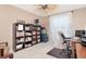 Functional home office with well-stocked bookshelf, desk, and view from window at 11121 Clayridge Dr, Tampa, FL 33635