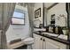 Stylish bathroom featuring black and white accents, a swan figurine, and a shower tub combo at 11327 Copley Ct, Spring Hill, FL 34609