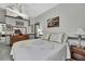 Well-lit bedroom featuring tasteful decorations, a comfortable bed, and a dresser with mirror at 11327 Copley Ct, Spring Hill, FL 34609