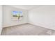 Bedroom with carpeted floors, a window with blinds, and ample space at 1226 Mumford Ct, Zephyrhills, FL 33540
