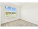 Bright and airy bedroom, carpeted with ample natural light from a large window and white walls at 1226 Mumford Ct, Zephyrhills, FL 33540
