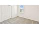 Bedroom with a closet, carpeted floor and a bright window at 1226 Mumford Ct, Zephyrhills, FL 33540