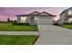 Charming home featuring a well-manicured lawn, driveway, and a two-car garage at 1226 Mumford Ct, Zephyrhills, FL 33540