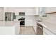 Bright kitchen with stainless steel appliances, white cabinetry, and a modern backsplash at 1226 Mumford Ct, Zephyrhills, FL 33540