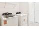 Laundry room with a washer and dryer, white cabinets, and tiled flooring at 1226 Mumford Ct, Zephyrhills, FL 33540