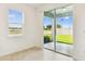 Bright room with large window and sliding glass door leading to the outside at 1226 Mumford Ct, Zephyrhills, FL 33540