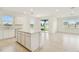 Modern open concept space offering natural light, tile flooring, and access to outdoor living at 1226 Mumford Ct, Zephyrhills, FL 33540