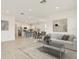 Open-concept living room featuring a modern sofa, stylish coffee table, and an inviting kitchen with a breakfast bar at 1226 Mumford Ct, Zephyrhills, FL 33540
