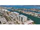 Aerial view of waterfront condos nestled within a picturesque coastal community with waterways and lush greenery at 125 Island Way # 404, Clearwater Beach, FL 33767