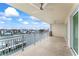 Condo balcony offers scenic views of the river, white railings, and two ceiling fans at 125 Island Way # 404, Clearwater Beach, FL 33767