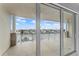 Spacious balcony with waterfront views, ceiling fan, and access via sliding glass doors at 125 Island Way # 404, Clearwater Beach, FL 33767