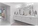 Bright bathroom with double vanity, quartz countertops, and modern lighting fixtures at 125 Island Way # 404, Clearwater Beach, FL 33767