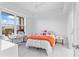 Bright bedroom features a large window, modern desk, and a cozy bed with a colorful throw blanket at 125 Island Way # 404, Clearwater Beach, FL 33767