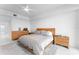 Bright bedroom with a platform bed, modern dresser, and bright white walls at 125 Island Way # 404, Clearwater Beach, FL 33767