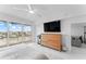 Bright bedroom with a large TV, balcony access, and white marble floors at 125 Island Way # 404, Clearwater Beach, FL 33767
