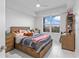 Inviting bedroom with light wood furnishings, large windows, and tiled floor at 125 Island Way # 404, Clearwater Beach, FL 33767
