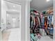 Walk-in closet with custom shelving, leading to a glass enclosed shower at 125 Island Way # 404, Clearwater Beach, FL 33767