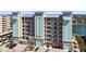 Multi-story condo building showcasing a modern design with waterfront views and ample parking spaces at 125 Island Way # 404, Clearwater Beach, FL 33767