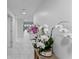 Bright hallway with decorative orchids, and tiled flooring at 125 Island Way # 404, Clearwater Beach, FL 33767