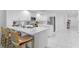 Bright white kitchen with bar stool seating at the island and modern appliances at 125 Island Way # 404, Clearwater Beach, FL 33767