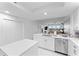 Bright white kitchen with stainless steel appliances overlooking the living room and a water view at 125 Island Way # 404, Clearwater Beach, FL 33767