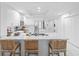 Modern white kitchen featuring an island with seating and stainless steel appliances at 125 Island Way # 404, Clearwater Beach, FL 33767